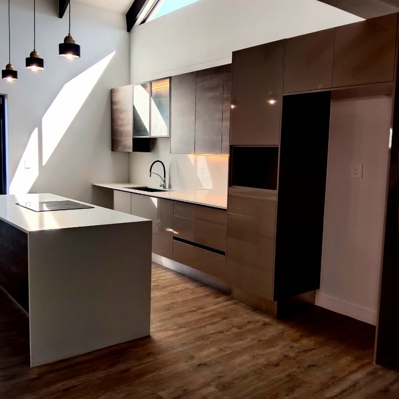 Open-plan kitchen with timber and white cabinetry